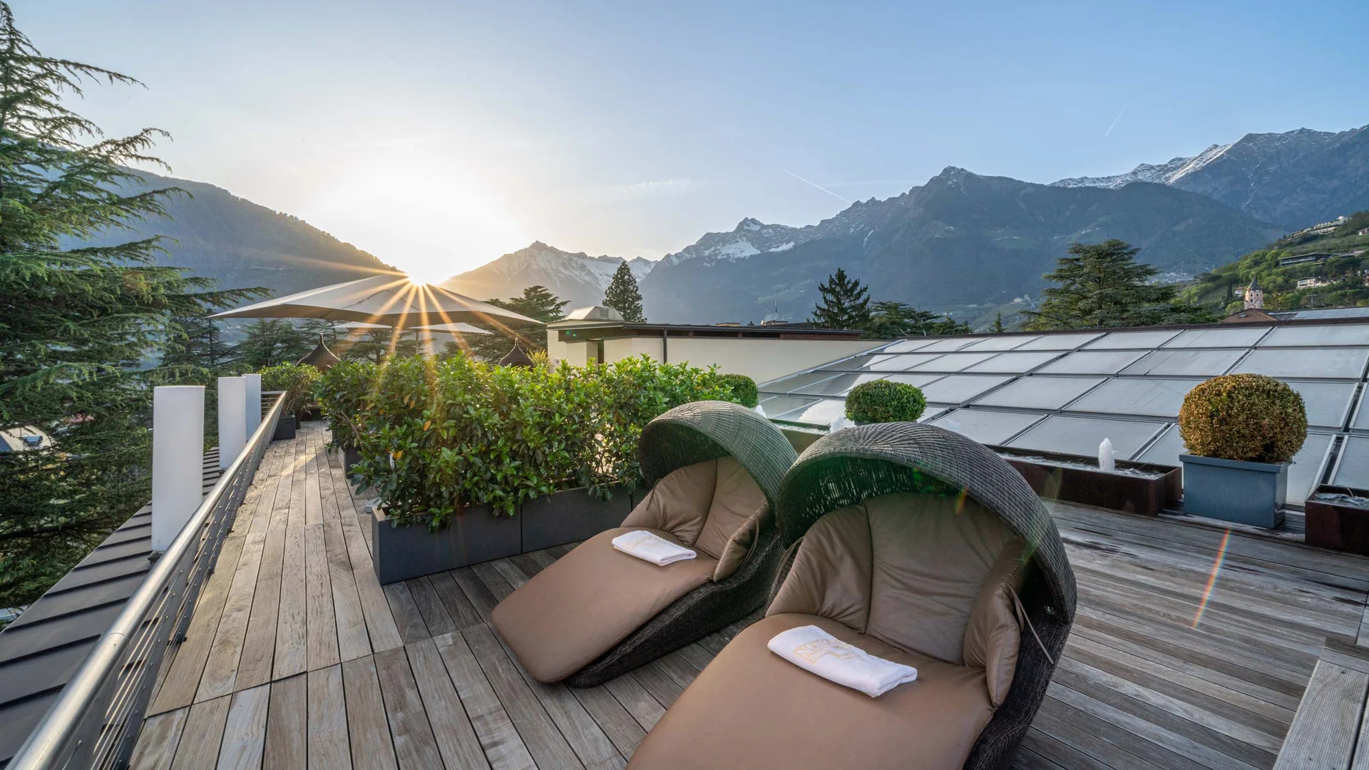 Lounge chairs on terrace with mountain view at sunset